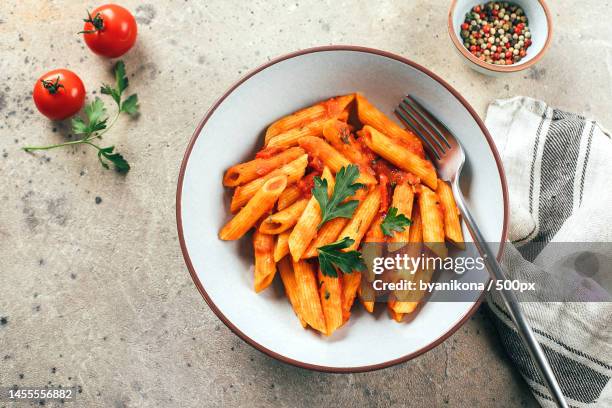 penne pasta with tomato sause in plate on stone background table top view italian food,kazakhstan - penne stock pictures, royalty-free photos & images