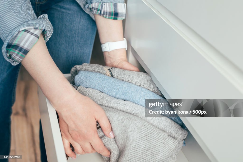 Woman folding clothes,Organizing stuff in drawer Concept of clothes storage,Minimalism lifestyle,Kazakhstan