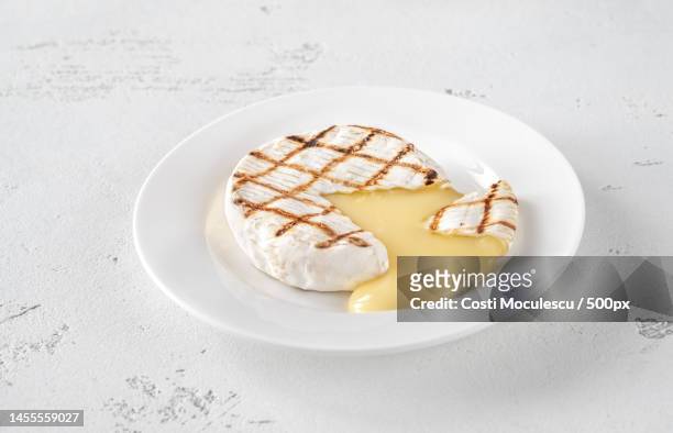 grilled camembert on the white plate cross section,romania - baked brie stock pictures, royalty-free photos & images