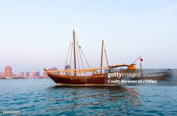 view of ship in sea against sky,qatar - dhow stock pictures, royalty-free photos & images