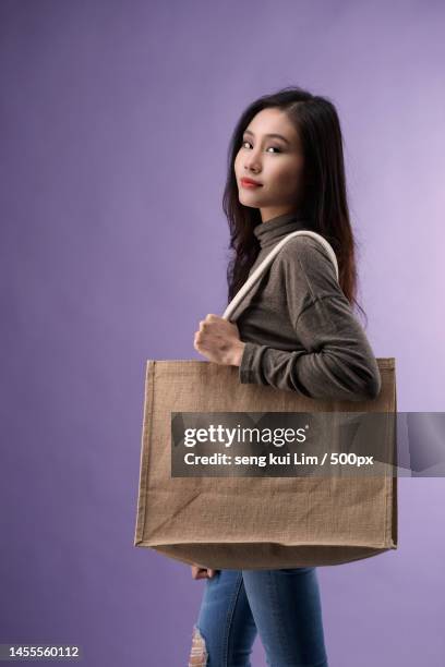 chinese women with sackcloth reuseable hand bag,malaysia - editorial template stock pictures, royalty-free photos & images