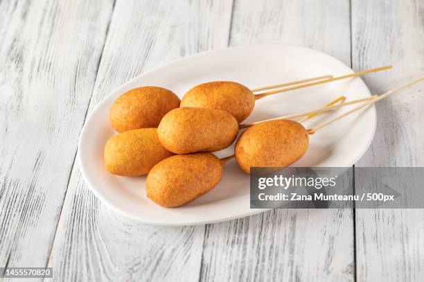 corn dogs on white serving plate,romania - cornmeal stock pictures, royalty-free photos & images