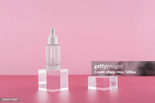 serum cosmetic bottle with peptides and retinol on acrylic blocks on - solid perfume stock pictures, royalty-free photos & images