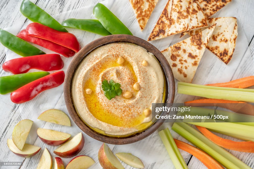 Bowl of hummus garnished with olive oil and paprika,Romania