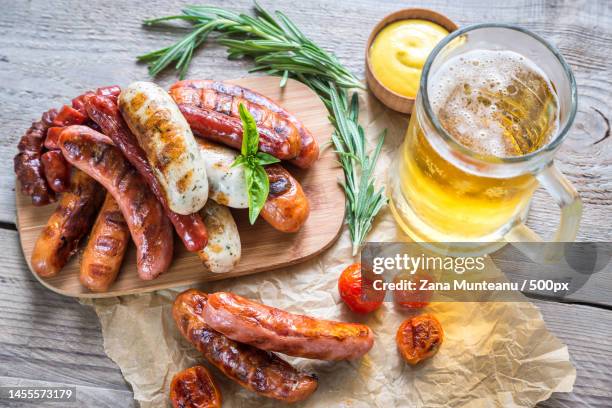 grilled sausages with glass of beer,romania - bierwurst stock-fotos und bilder