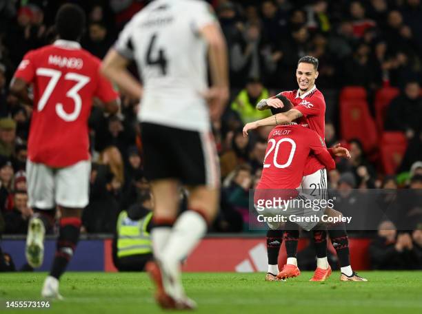 Antony of Manchester United celebrates with teammate Diogo Dalot after scoring the team's first goal during the Carabao Cup Quarter Final match...