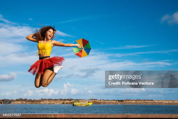 frevo dancer jumping at brazilian carnival - carnaval recife stock pictures, royalty-free photos & images