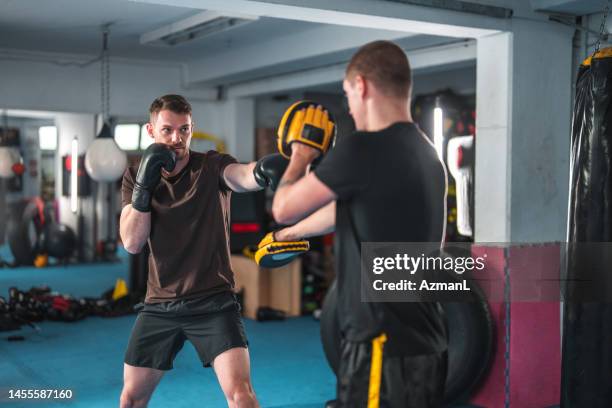 caucasian males at boxing practice - fighting stance stock pictures, royalty-free photos & images