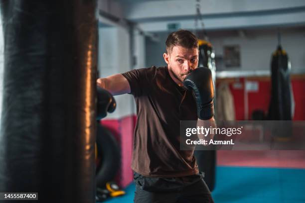 young athletic male professional boxer exercising and training - boxboll bildbanksfoton och bilder