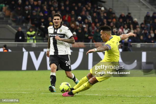 Lautaro Martinez of FC Internazionale scores the team's first goal under pressure from Stanko Juric of Parma Cacio during the Coppa Italia Round of...