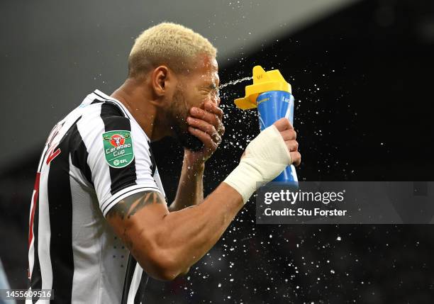 Newcastle player Joelinton sprays his face with water prior to the Carabao Cup Quarter Final match between Newcastle United and Leicester City at St...