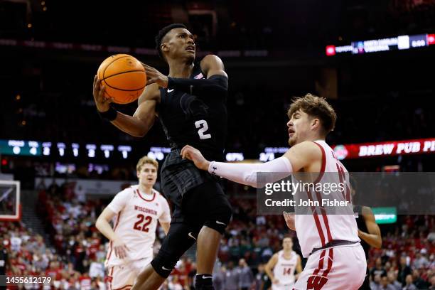 Tyson Walker of the Michigan State Spartans drives to the basket on Max Klesmit of the Wisconsin Badgers during the first half at Kohl Center on...