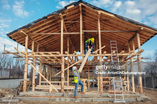 builders workig on wooden house. - house construction frame stock pictures, royalty-free photos & images
