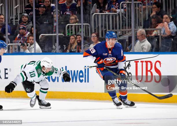 Ty Dellandrea of the Dallas Stars and Brock Nelson of the New York Islanders collide as Nelson skates awqy with Dellandrea's stick during the first...