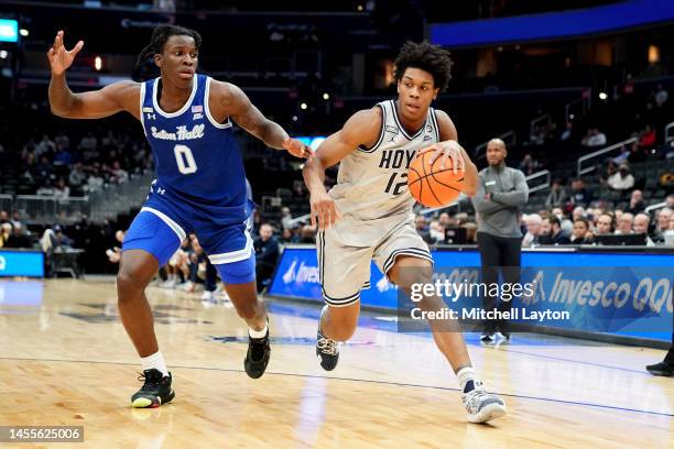 Jordan Riley of the Georgetown Hoyas dribbles by Kadary Richmond of the Seton Hall Pirates in the first half during a college basketball game at...