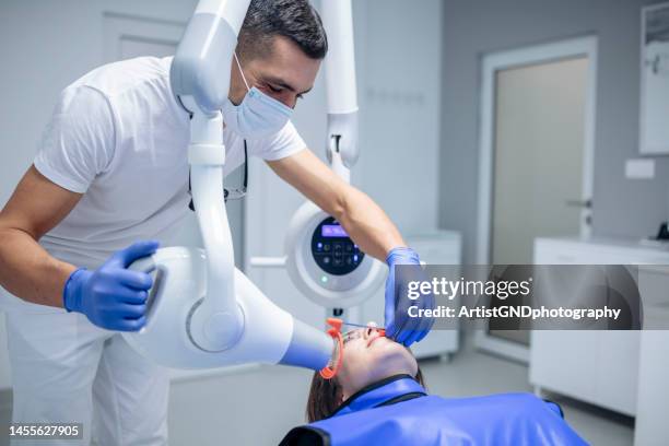 dentist taking x-rays of patient. - dental equipment stock pictures, royalty-free photos & images