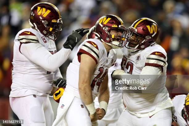 Quarterback Sam Howell of the Washington Commanders celebrates after rushing for a touchdown against the Dallas Cowboys at FedExField on January 08,...