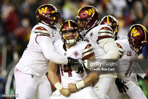 Quarterback Sam Howell of the Washington Commanders celebrates after rushing for a touchdown against the Dallas Cowboys at FedExField on January 08,...