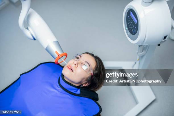 dentist taking x-rays of patient. - dental imaging stock pictures, royalty-free photos & images