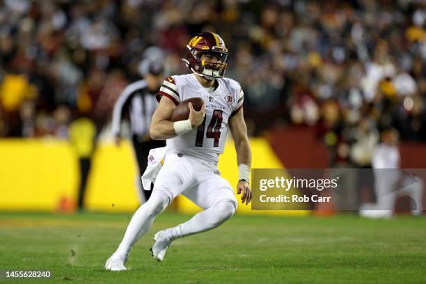 Quarterback Sam Howell of the Washington Commanders runs with the ball against the Dallas Cowboys at FedExField on January 08, 2023 in Landover,...