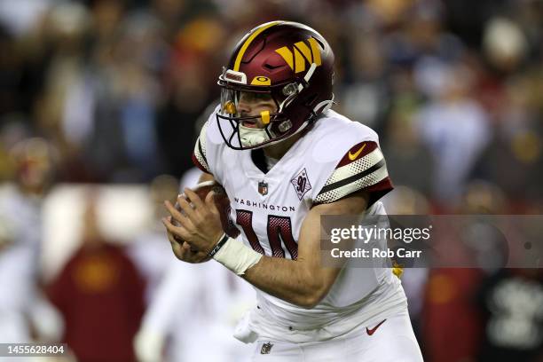 Quarterback Sam Howell of the Washington Commanders runs with the ball against the Dallas Cowboys at FedExField on January 08, 2023 in Landover,...