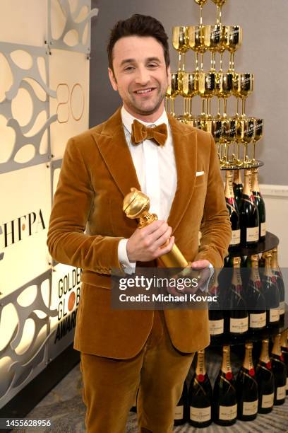 Justin Hurwitz poses with the Best Original Score award for "Babylon" at the 80th Annual Golden Globe Awards with Moët And Chandon at The Beverly...