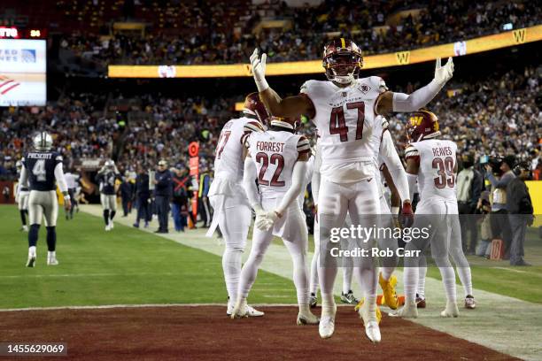 Linebacker Khaleke Hudson of the Washington Commanders celebrates after the Commanders returned an interception for a touchdown against the Dallas...