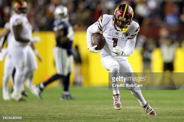 Wide receiver Jahan Dotson of the Washington Commanders runs with the ball after catching a pass against the Dallas Cowboys at FedExField on January...