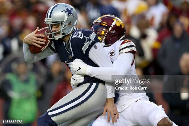 Linebacker Milo Eifler of the Washington Commanders tackles punter Bryan Anger of the Dallas Cowboys during a botched punt on fourth down in the...