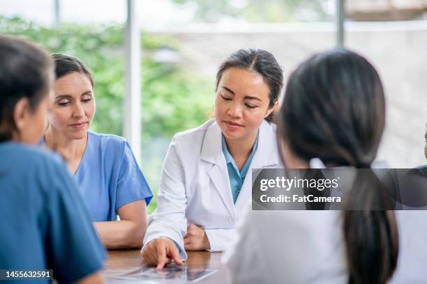 medical professionals meeting - medical partnership stock pictures, royalty-free photos & images