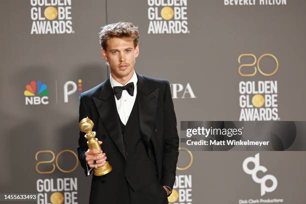 Austin Butler poses with the Best Actor in a Motion Picture – Drama award for "Elvis" in the press room during the 80th Annual Golden Globe Awards at...