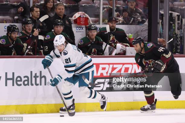 Michael Eyssimont of the San Jose Sharks skates with the puck ahead of Zack Kassian of the Arizona Coyotes during the first period of the NHL game at...