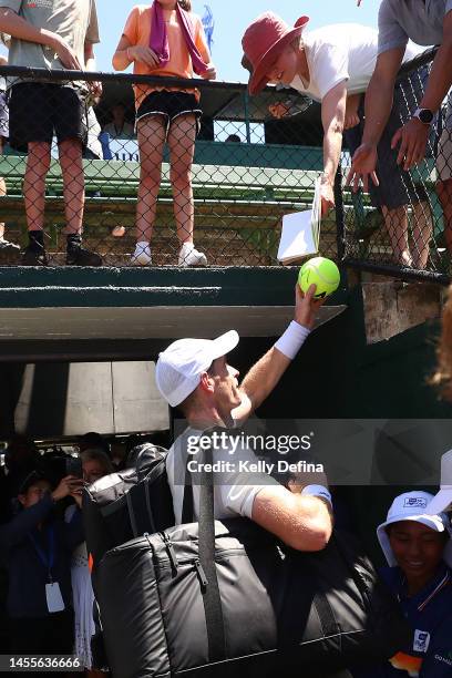 Andy Murray of Great Britain signs autographs for supporters after the match during day two of the 2023 Kooyong Classic at Kooyong on January 11,...