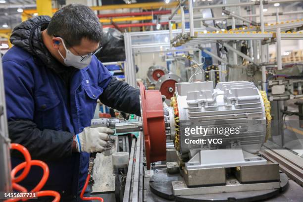 An employee works on the production line of motors at Weg Electric Motor Manufacturing Co., Ltd. On January 9, 2023 in Nantong, Jiangsu Province of...