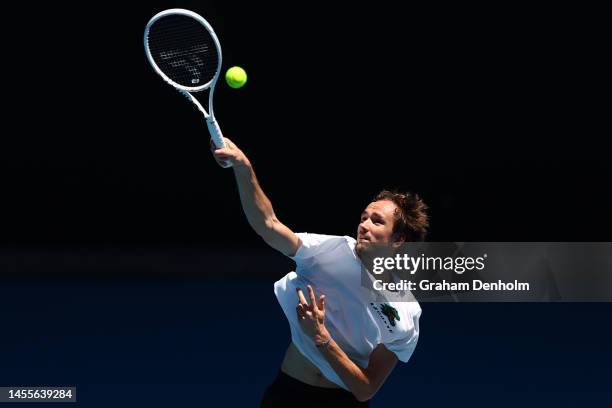 Daniil Medvedev of Russia serves in a practice match against Novak Djokovic of Serbia ahead of the 2023 Australian Open at Melbourne Park on January...