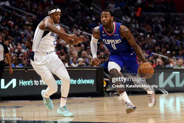 John Wall of the Los Angeles Clippers drives past Frank Ntilikina of the Dallas Mavericks during the second quarter at Crypto.com Arena on January...