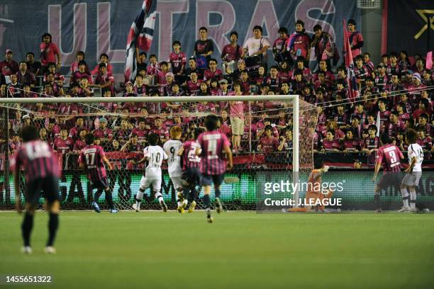 Jumpei Kusukami of Kawasaki Frontale scores the team's first goal past Kenya Matsui of Cerezo Osaka during the J.League Yamazaki Nabisco Cup Group A...
