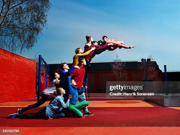 young people creating human statue - leveling the playing field stock pictures, royalty-free photos & images