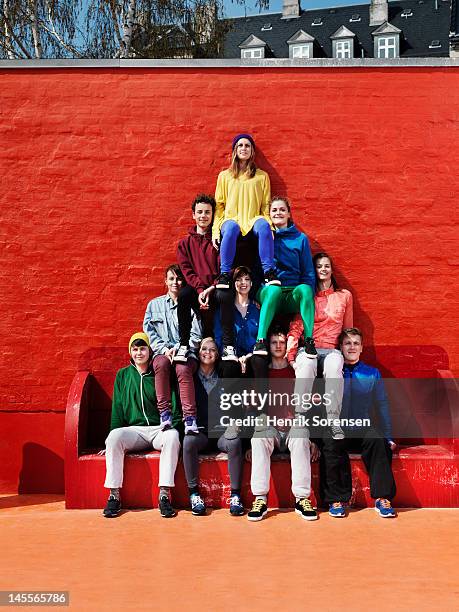 young people forming a pyramid - human pyramid stock pictures, royalty-free photos & images