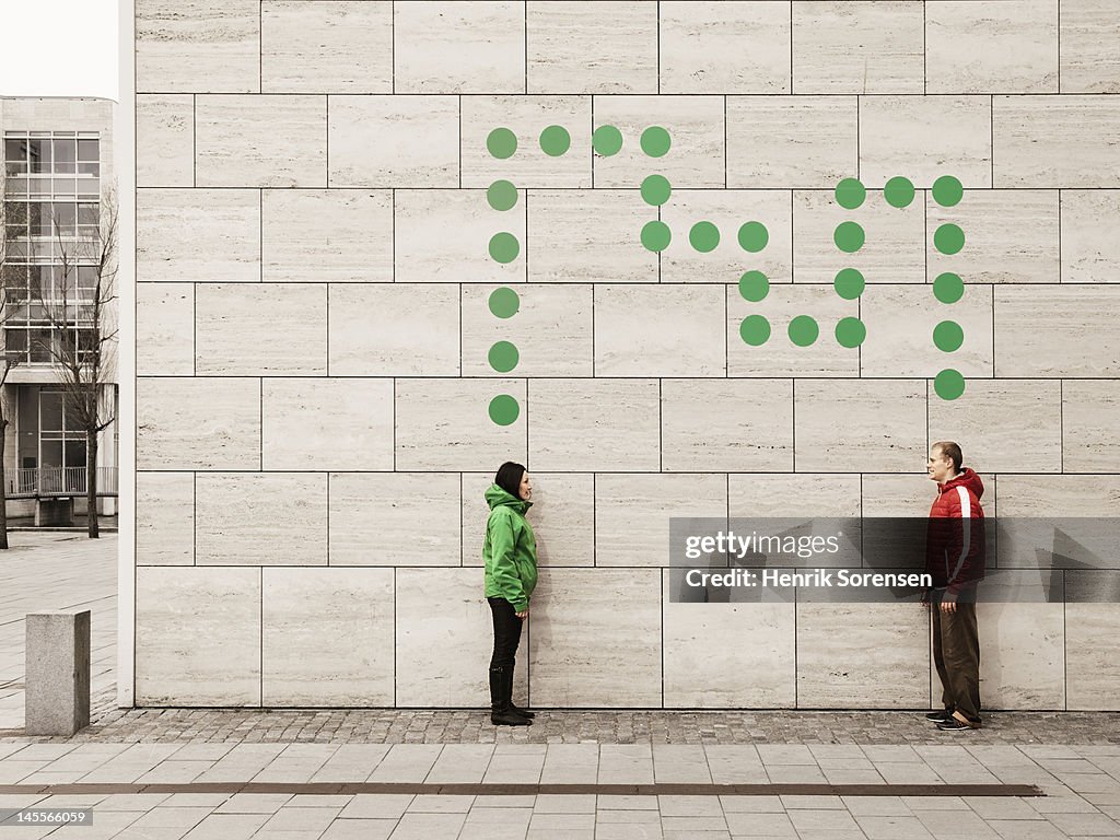 Two young people connected with dots