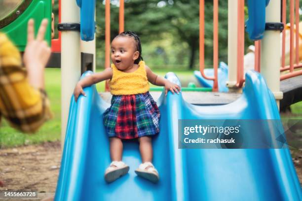 playing on the slide in the park - girl sandals stock pictures, royalty-free photos & images