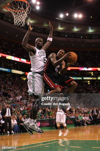 Mario Chalmers of the Miami Heat drives for a shot attempt in the seocnd half against Kevin Garnett of the Boston Celtics in Game Three of the...