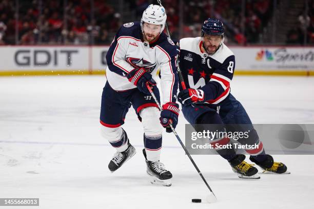 Sean Kuraly of the Columbus Blue Jackets and Alex Ovechkin of the Washington Capitals battle for the puck during the third period of the game at...