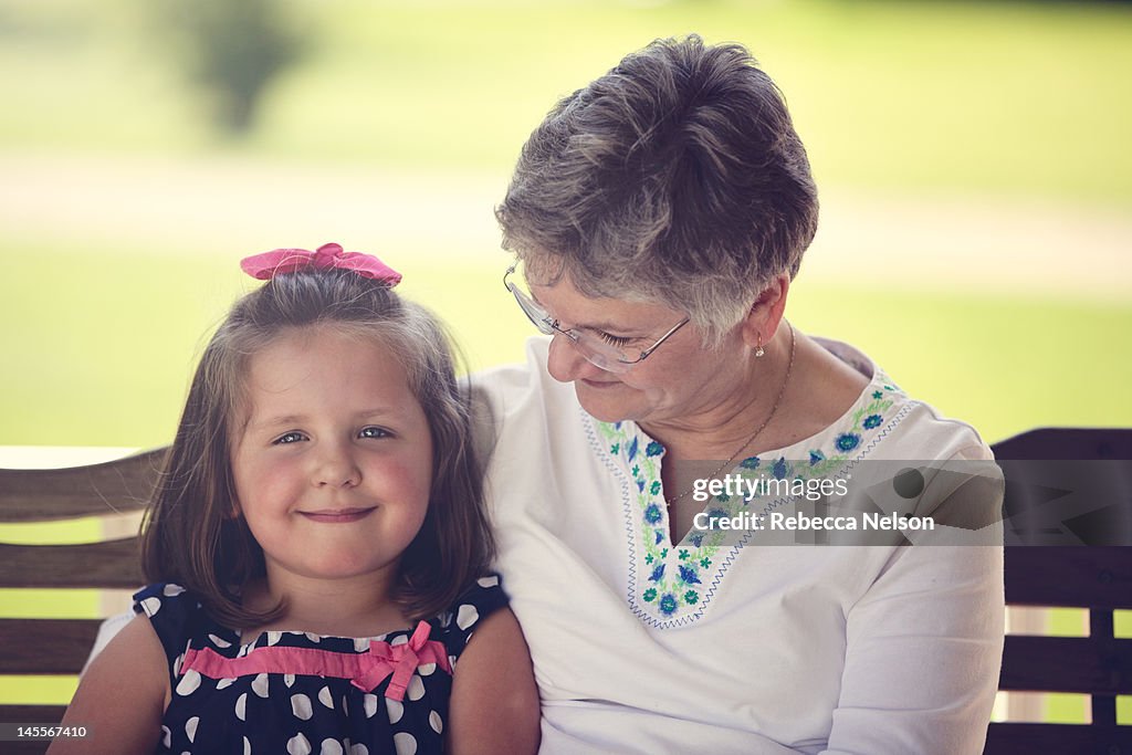 Grandmother and granddaughter on swing