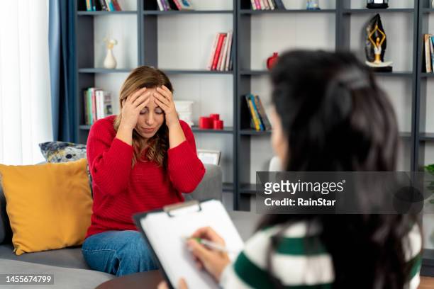 female patient feels depressed during a psychotherapist session - story telling in the workplace stock pictures, royalty-free photos & images