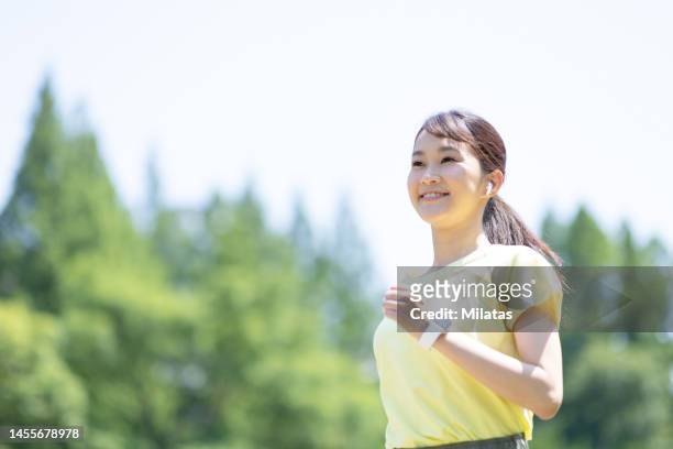woman running in the park - woman jogging ストックフォトと画像