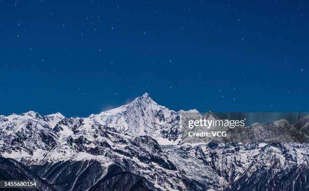 Starry sky is pictured over the Meili Snow Mountains on January 4, 2023 in Diqing Tibetan Autonomous Prefecture, Yunnan Province of China.