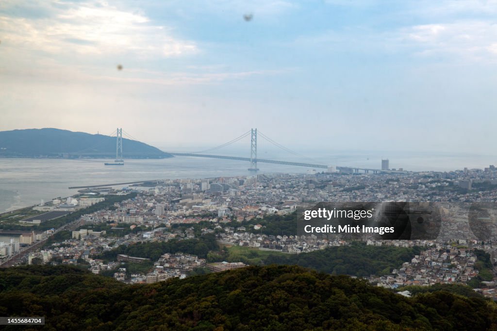View over the city of Kobe and Akashi Kaikyo Bridge suspension bridge, linking Honshu to Iwaya