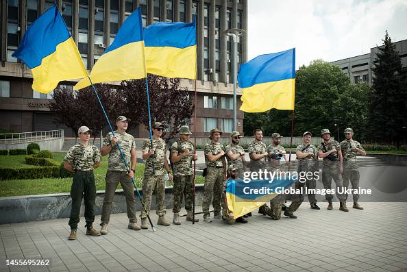Azoz Regiment Soldiers of the Azov Regiment pose after running, holding state flags ...