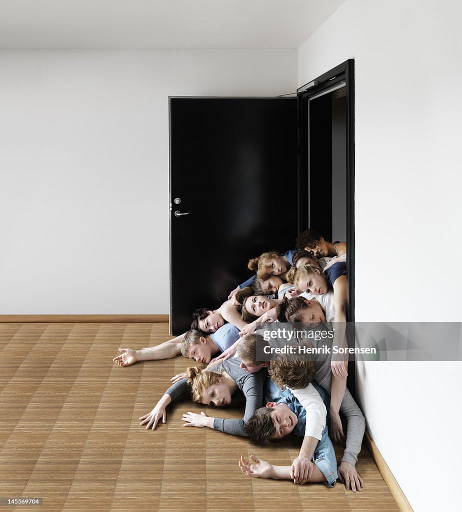 Young people falling out of a door.